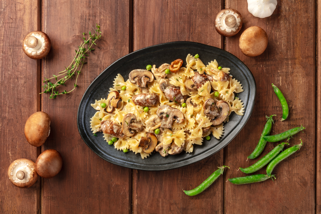 Pasta con panna, funghi e piselli